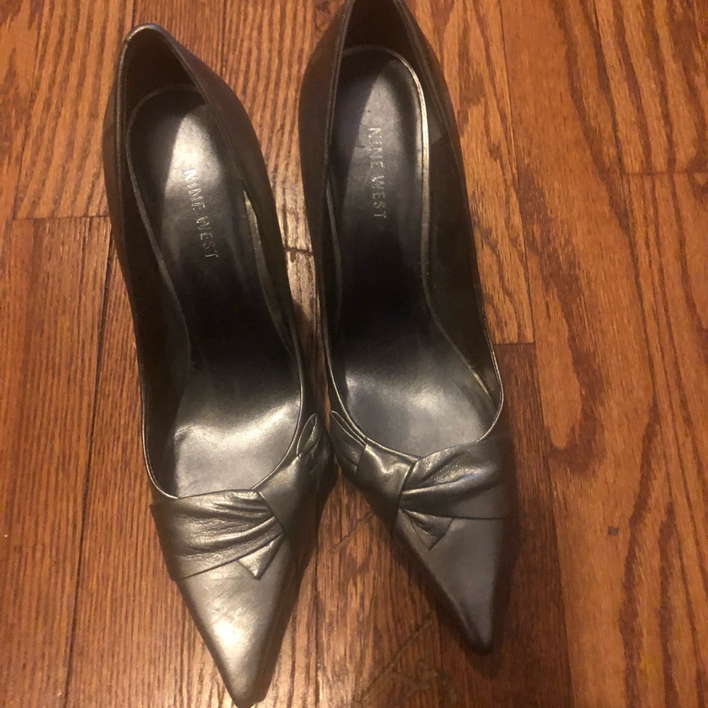 Gently worn silver Nine West heels with a side bow
